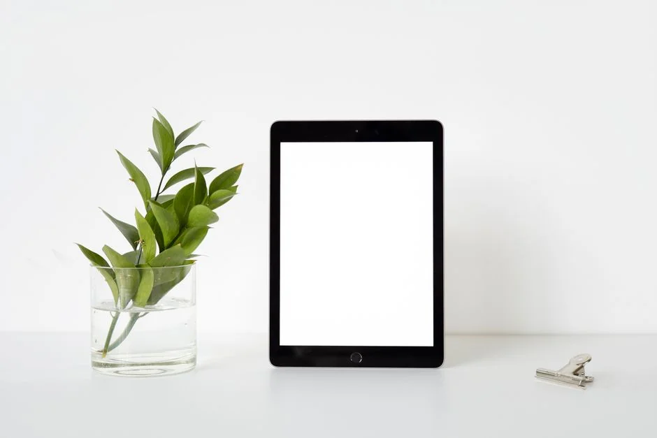 A tablet displaying a financial website, placed beside a white keyboard and mouse. Perfect for stock images with a tech-focused theme.